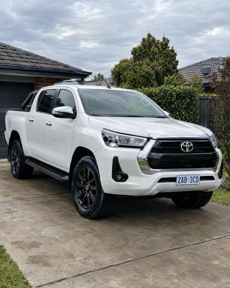 White dual-cab ute detailed in a suburban driveway